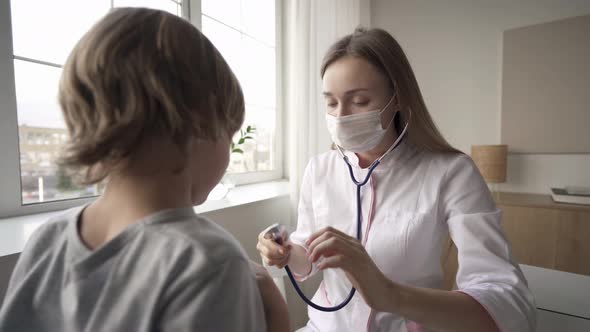 Pediatrician Doctor Woman Uniform Hold Stethoscope Annual Check Up Toddler Boy By Monitoring Heart