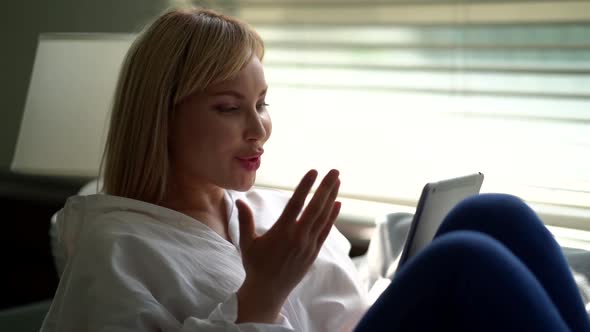 Young Woman Is Shopping Online, Browsing Internet Site of Store By Tablet, Viewing Photos