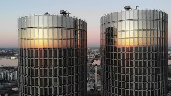 Aerial view of rooftops of twin glass skyscrapers with sunset in reflection in Riga, Latvia