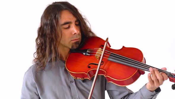 Hispanic male musician with long brown hair playing red viola instrument in slow motion against whit