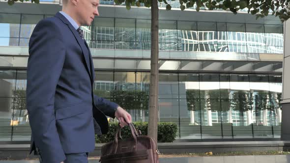 Businessman Coming and Sitting Outside Office Waiting