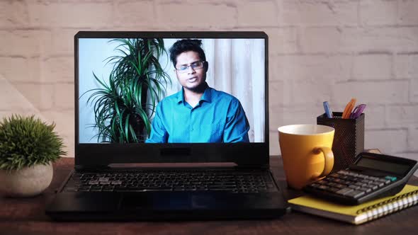 Businessman In a Video Conference Display on Laptop Screen