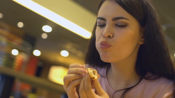 Young Brunette Female Chewing Tasty Sandwich, Sitting in Burger Restaurant, Meal