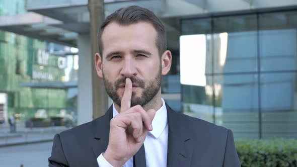 Silence Please, Finger on Lips By Beard Businessman