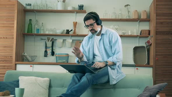 A Man Videocalls Colleagues Via Laptop During Quarantine