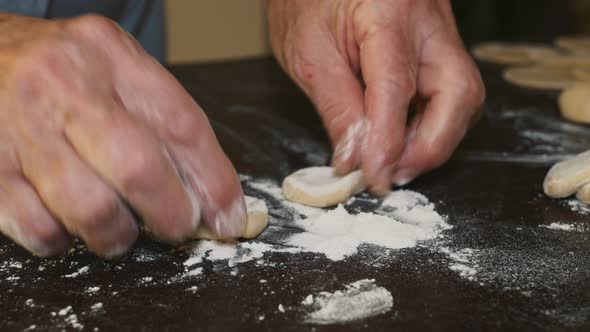 Closeup Shot of Dough Balls Dipped in Flour on the Table Grandmother Prepares Dough at Home for a