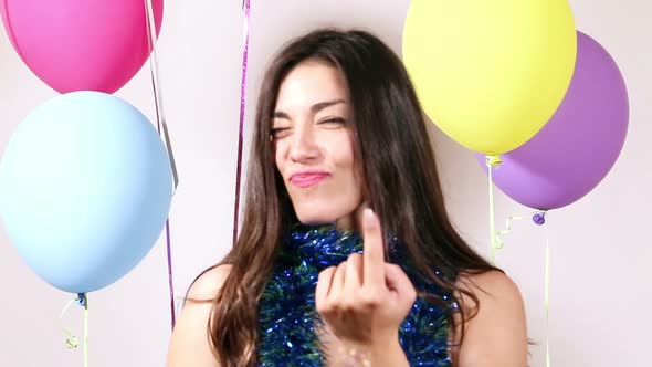 Close up of brunette woman playing with props in party photo booth