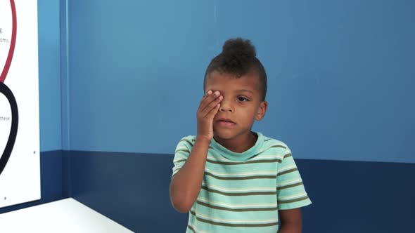 Doctor Ophthalmologist Checks Vision of Child Boy