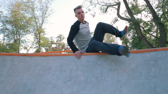 Young Man Doing Parkour Tricks in Extreme Sports Park