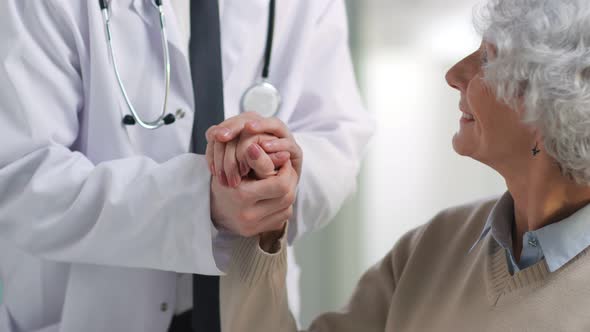 Cropped Shot of Doctor in White Coat Holding Hand of Senior Patient