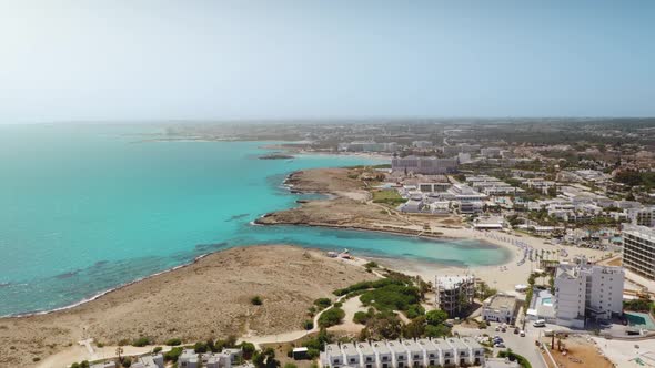 Rise Up Drone View of Coastal Resort Ayia Napa Town with Blue Sea Water and Sand Beach