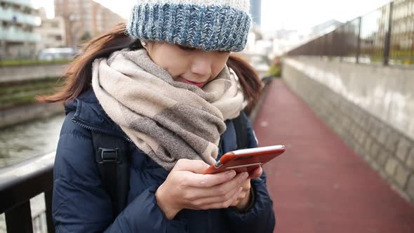 Woman using mobile phone at outdoor