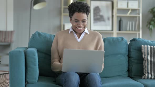 Cheerful African Girl Working on Laptop