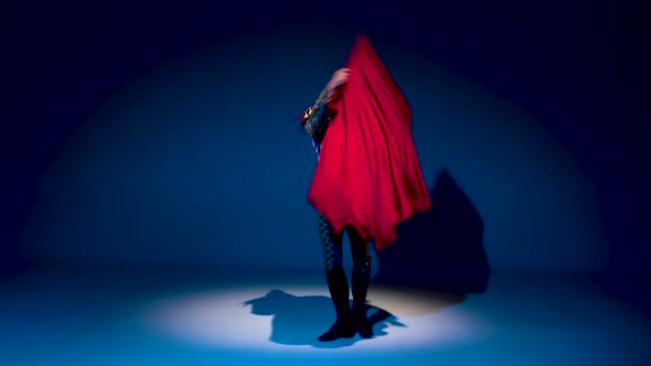 Torero in Blue and Gold Suit or Typical Spanish Bullfighter Isolated Spotlight on a Blue Background