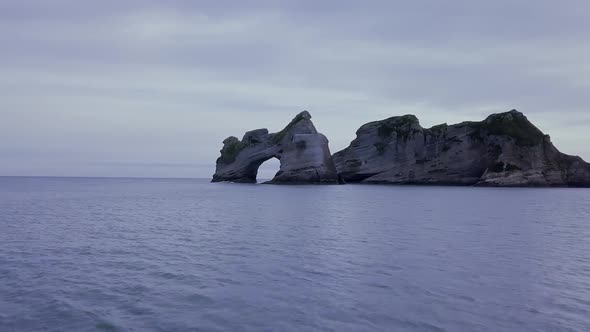 Rock with archway in the ocean