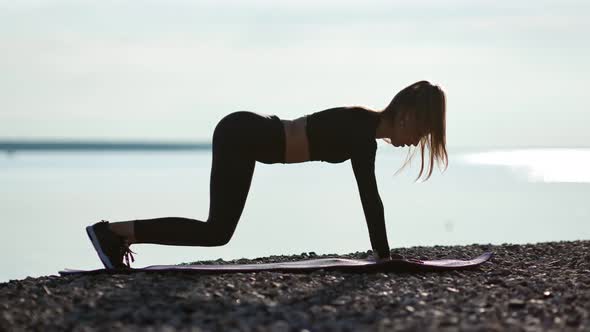 Athletic Female Doing Sports Exercise Stand on Mat Raising Hand