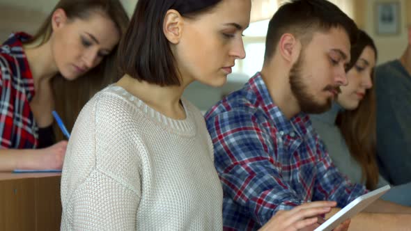 Female Student Flips on Tablet