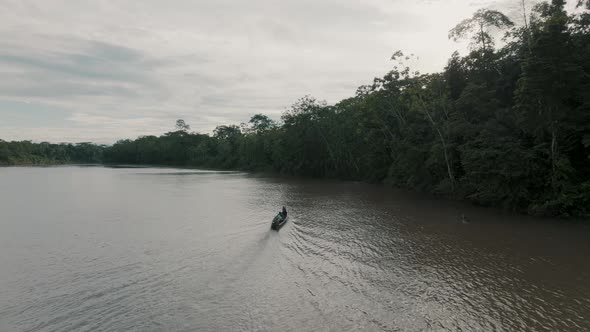 Tourist Riding A Mobile Canoe Is Driving Over A Lagoon In The Amazon Rainforest Of Ecuador. Aerial W