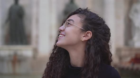 Smiling Moroccan Woman In Glasses Admires Beauty Of City Buildings