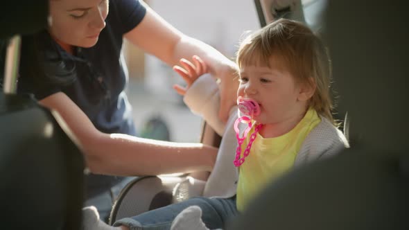 Mom Puts Her Daughter in a Baby Car Seat