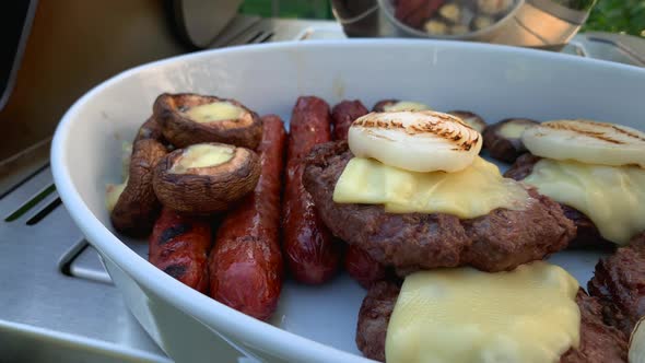 Grilled Burgers with Melted Cheese Sausage and Mushrooms on a White Plate