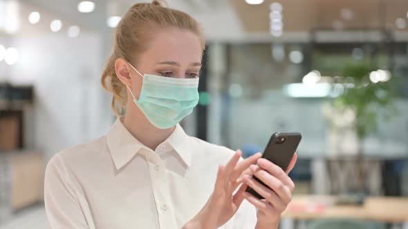 Portrait of Young Businesswoman with Face Mask Using Smartphone