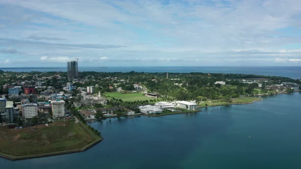 Aerial of peninsula city Suva on mainland of Fiji, view of Albert Park, urban