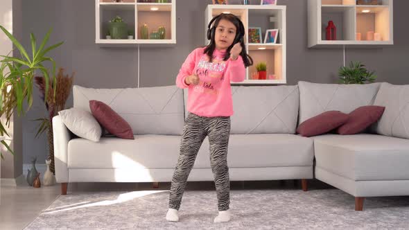 Girl child dancing at home. alt