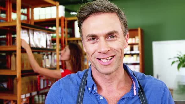 Smiling male staff standing in super market