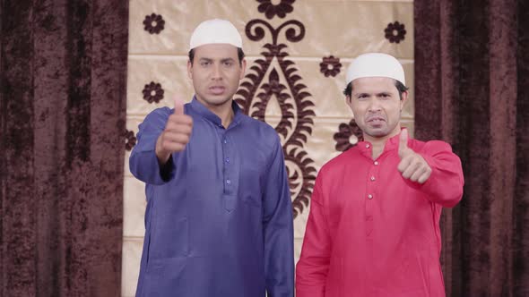 2 Muslim men showing thumbs up