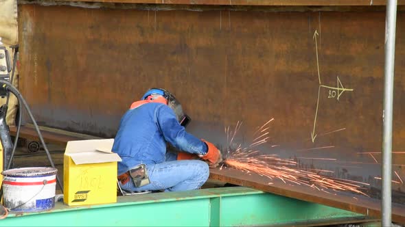 Worker Sitting and Welding