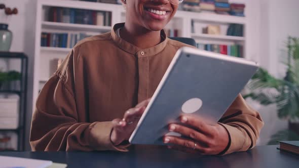 Crop Face of Young African Woman Using Digital Tablet Software Applications