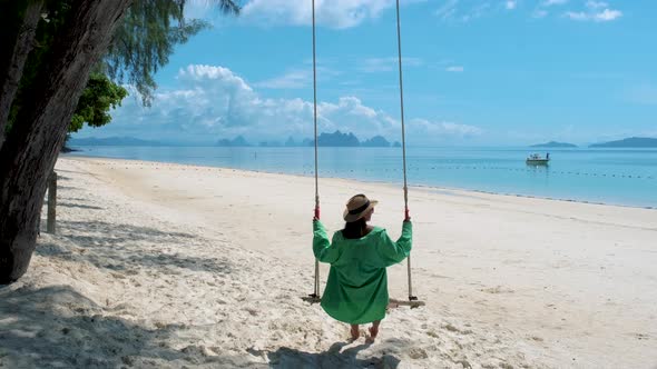 Woman on the Beach of Tropical Island Naka Island Phuket Thailand a Woman on a Swing on the Beach