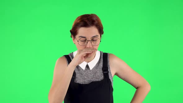 Portrait of Funny Girl in Round Glasses Is Getting a Cold, Sore Throat and Head, Cough. Green Screen