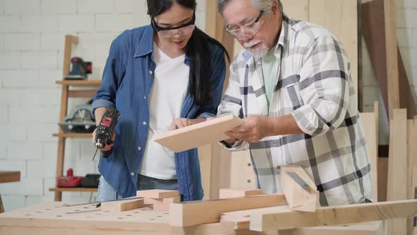 Senior man and woman working with wood