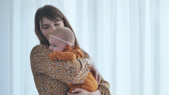 A Loving Mother and Child at the Window with Curtains