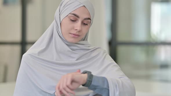 Young Arab Woman Using Smartwatch
