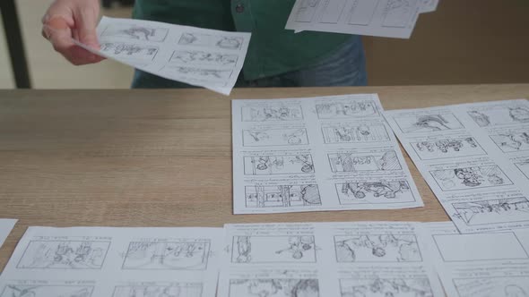 Creative Designer Works On A Storyboard, Looks At His Sketches And Concepts