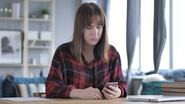 Sad Young Girl Reacting to Failure on Smartphone