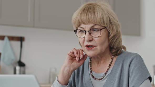 Elderly Woman Having Discussion on Video Call at Home