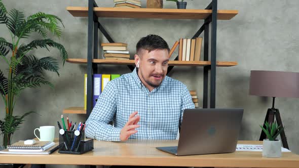 Emotional businessman tells investors online video call webcam laptop in office