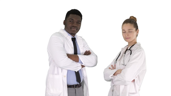 Woman and man doctors with crossed arms on white background.