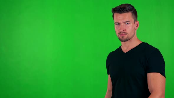 Young Handsome Caucasian Man Points on Watch (Show Time) - Green Screen - Studio