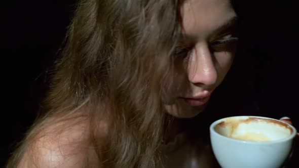 Closeup of Girl Drinking Coffee with Pleasure From a White Cup