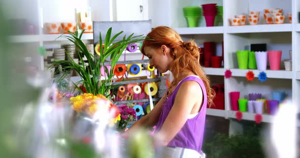 Female florist working in flower shop