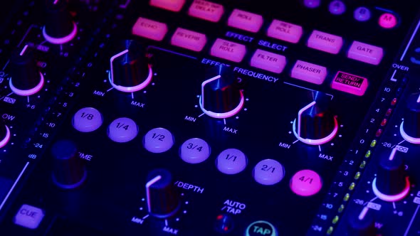 DJ Switches Channel on Mixing Console and Turns Up Volume By Moving Fader Closeup