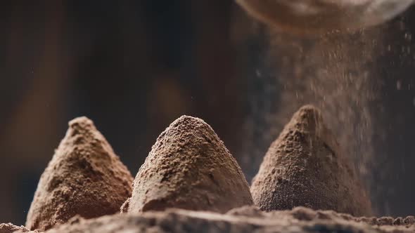 Cocoa powder falling on luxury homemade truffle candies
