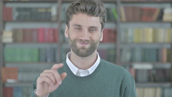 Upset Young Man Saying No with Finger Sign