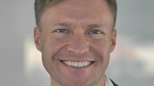 Close Up of Smiling Face of Businessman Looking at Camera