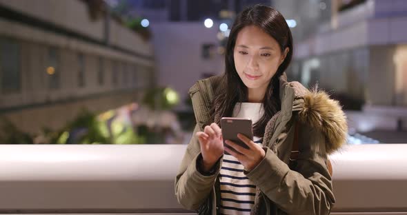 Woman use of smart phone at night